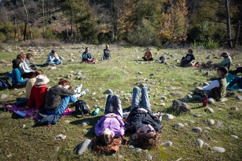 circle of people laying on the grass at community park